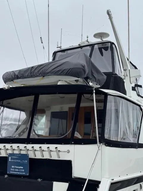 Slide: The Image of 1978 Hatteras 58 Cockpit Motor Yacht with covered upper deck and enclosed cockpit. - 51