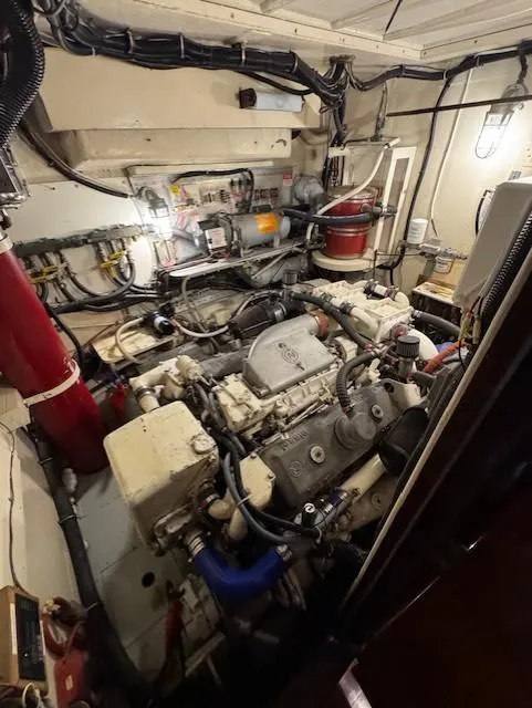 Slide: The Image of Engine room of 1978 Hatteras 58 Cockpit Motor Yacht, showcasing complex machinery and wiring. - 6
