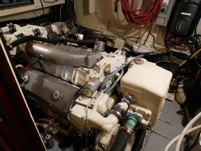 Slide: The Image of Engine room of 1978 Hatteras 58 Cockpit Motor Yacht with visible machinery and wiring. - 7