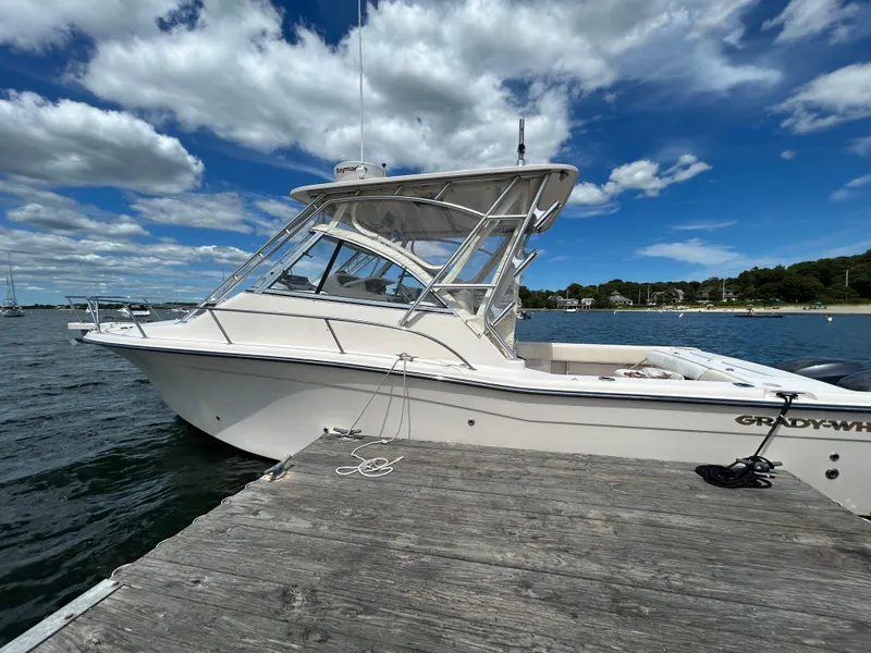 The Image of 2007 Grady-White Express 305 boat docked by the water under a partly cloudy sky. - 0