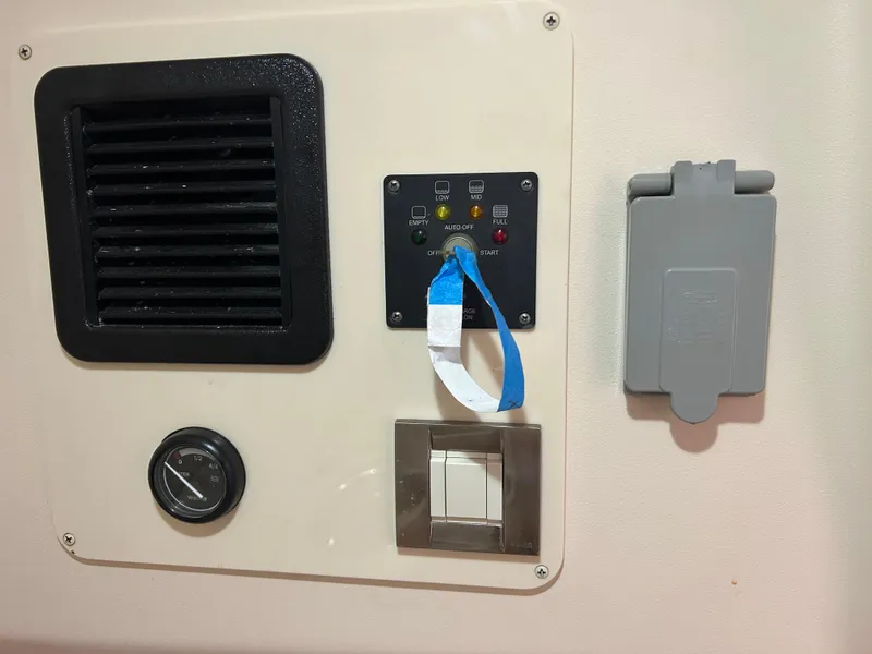 Slide: The Image of Control panel on a 2007 Grady-White Express 305 boat interior. - 11