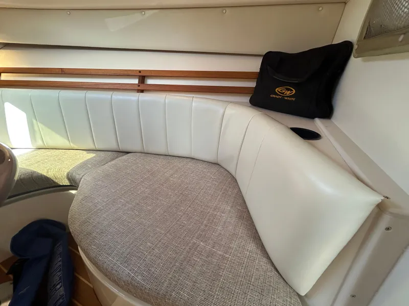 Slide: The Image of 2007 Grady-White Express 305 interior with cushioned seating and branded bag. - 13
