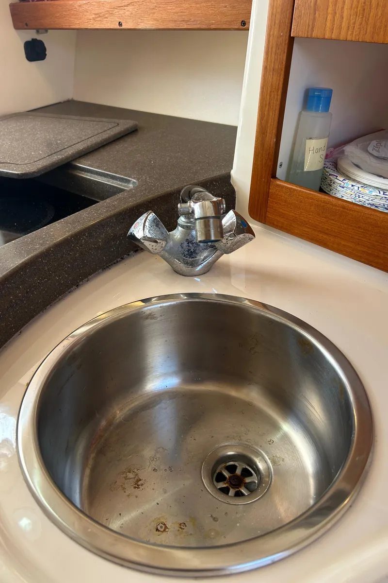 Slide: The Image of 2007 Grady-White Express 305 boat sink with faucet and countertop. - 15