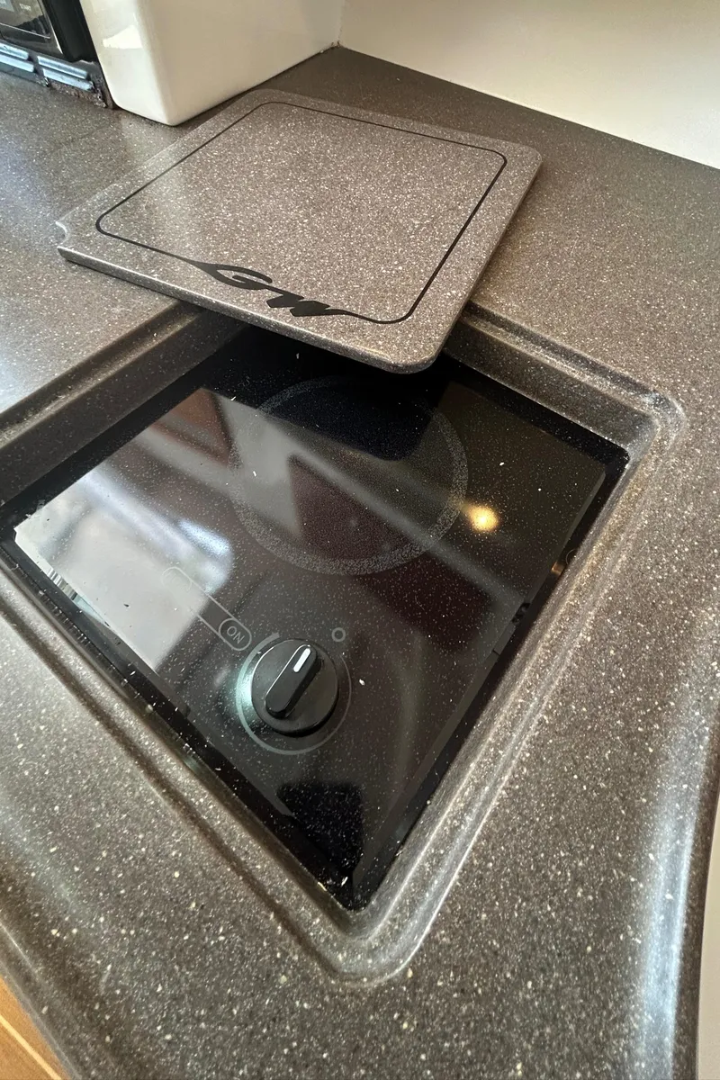 Slide: The Image of 2007 Grady-White Express 305 boat stove with cover, sleek countertop design. - 18