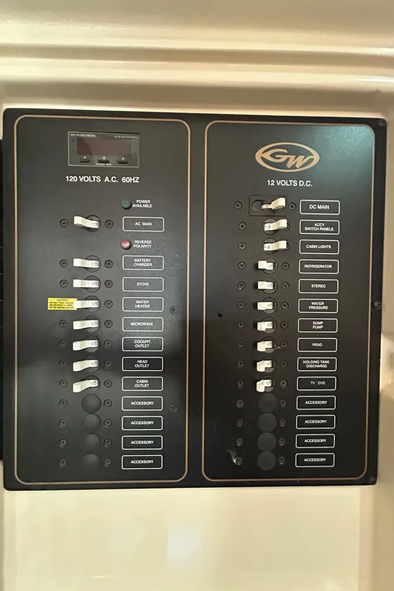 Slide: The Image of Electrical panel of a 2007 Grady-White Express 305 boat, showing 120V AC and 12V DC switches. - 19