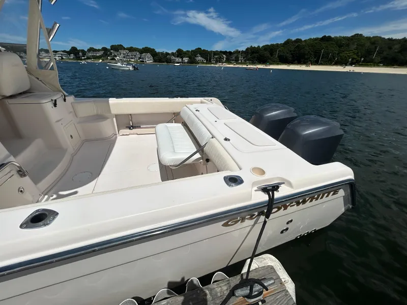 Slide: The Image of 2007 Grady-White Express 305 boat docked on calm water, scenic shoreline in background. - 2