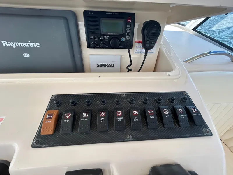 Slide: The Image of Control panel of a 2007 Grady-White Express 305 boat with Raymarine and Simrad equipment. - 25