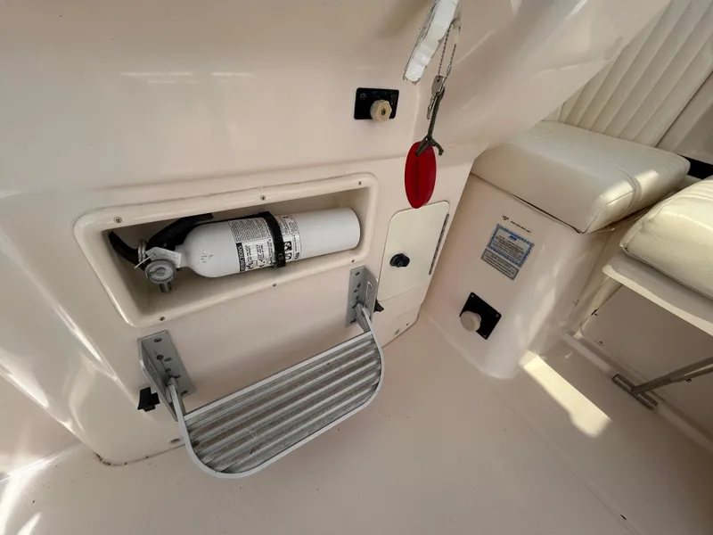 Slide: The Image of 2007 Grady-White Express 305 interior with fire extinguisher and seating area. - 27