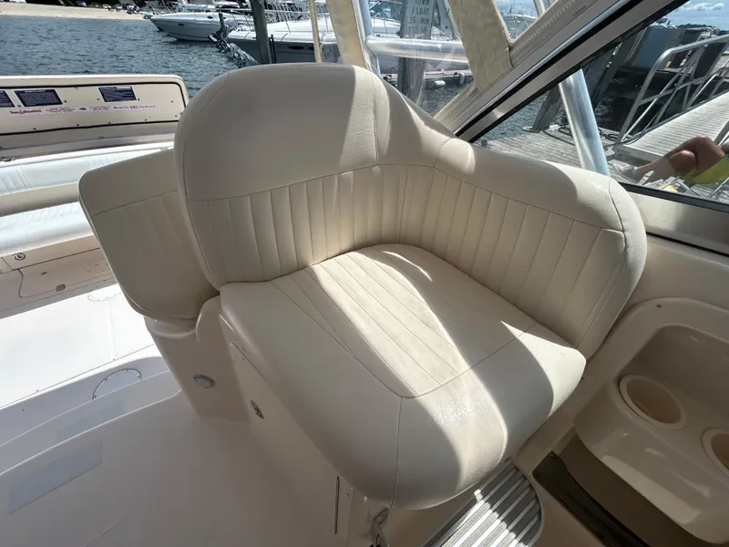 Slide: The Image of 2007 Grady-White Express 305 boat interior with cream leather seating, docked at marina. - 30