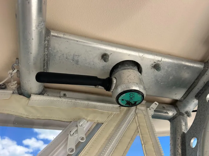 Slide: The Image of Close-up of a 2007 Grady-White Express 305 boat's T-top mount with TACO handle. - 36