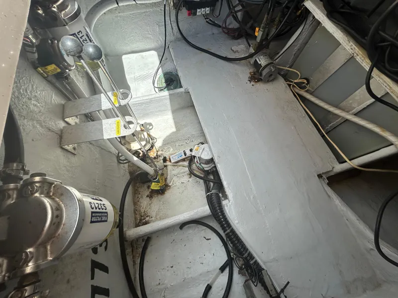 Slide: The Image of Engine compartment of a 2007 Grady-White Express 305 boat, showing mechanical components and wiring. - 38