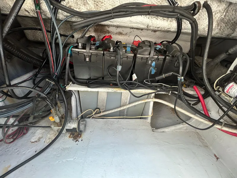 Slide: The Image of 2007 Grady-White Express 305 boat battery compartment with wiring and connections. - 39
