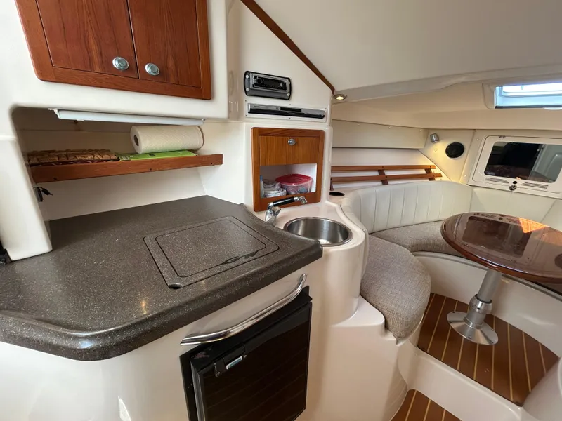 Slide: The Image of 2007 Grady-White Express 305 cabin interior with kitchenette and seating area. - 4