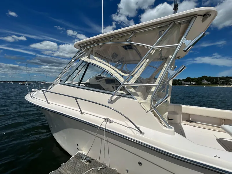 Slide: The Image of 2007 Grady-White Express 305 boat docked under a clear blue sky. - 41