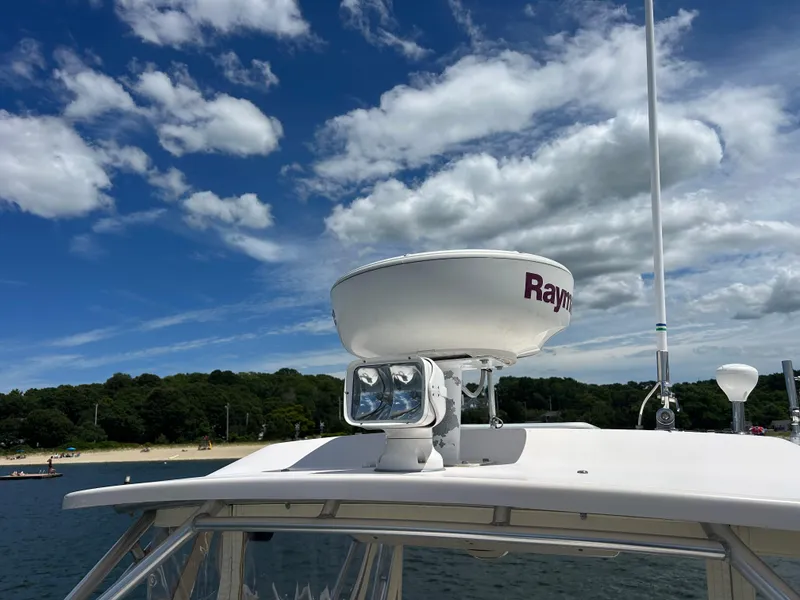 Slide: The Image of 2007 Grady-White Express 305 boat with radar, under a partly cloudy sky. - 45