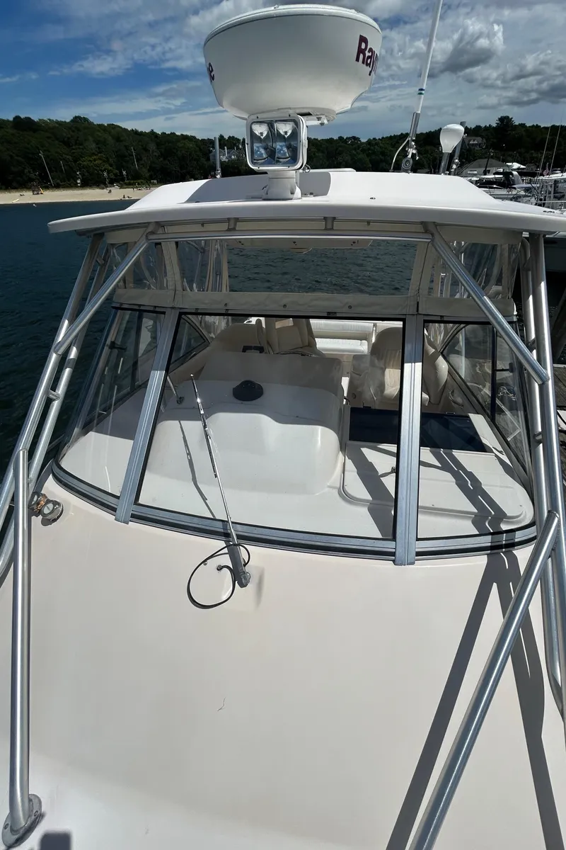 Slide: The Image of 2007 Grady-White Express 305 boat docked, featuring a spacious deck and radar equipment. - 46