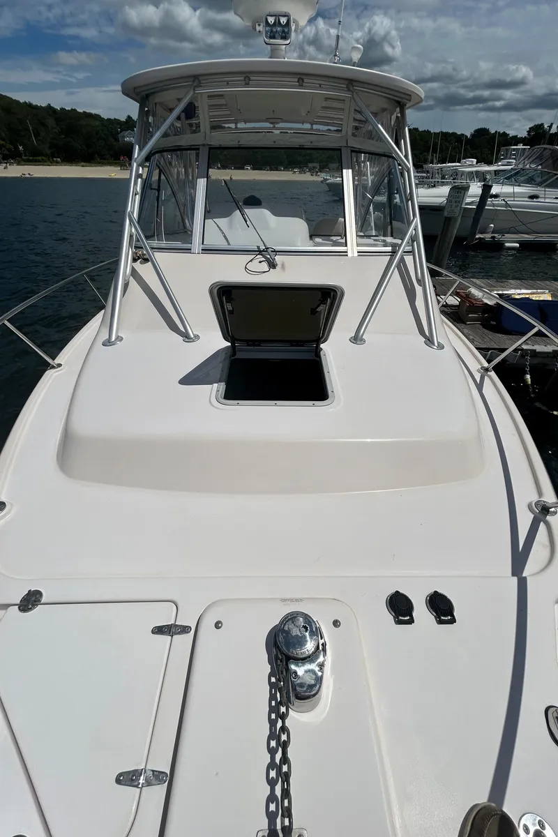 Slide: The Image of 2007 Grady-White Express 305 boat docked, open hatch, clear sky, calm water. - 47