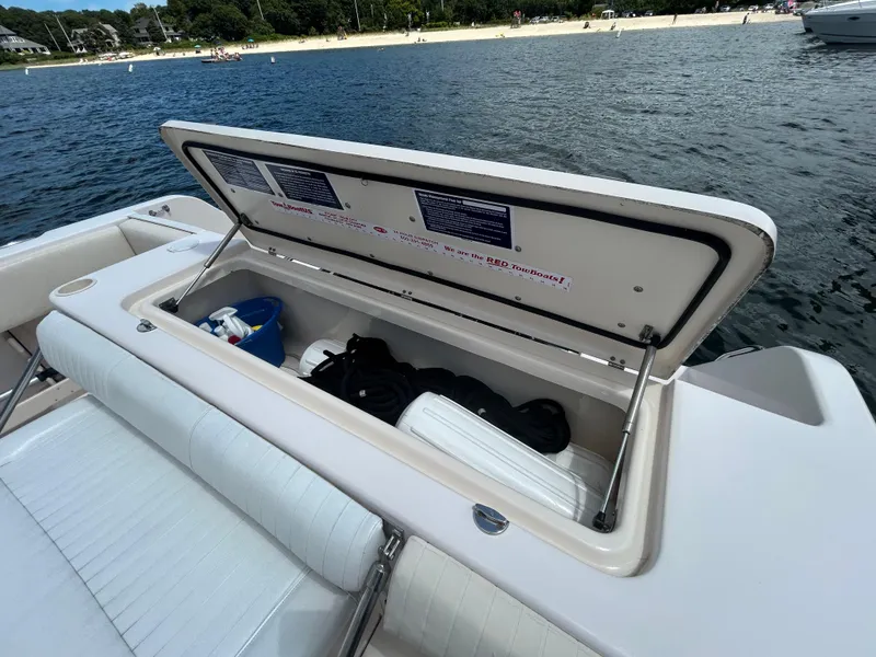 Slide: The Image of Open storage compartment on 2007 Grady-White Express 305 boat, near a sandy beach. - 48