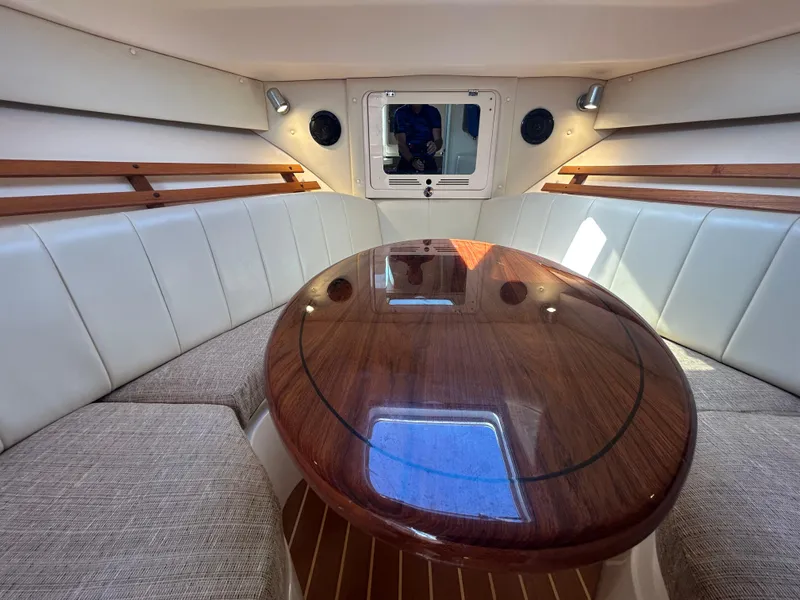 Slide: The Image of Interior of 2007 Grady-White Express 305 boat with elegant wood table and cushioned seating. - 7