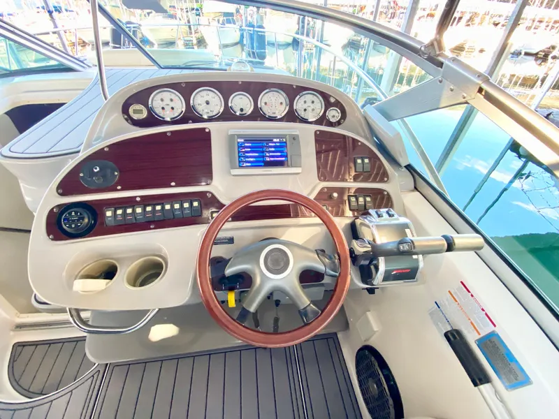 Slide: The Image of 2004 Chaparral Signature 330 helm with gauges, steering wheel, and control panel. - 13