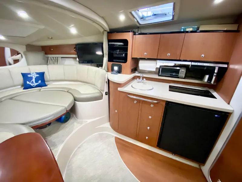 Slide: The Image of Luxurious 2004 Chaparral Signature 330 yacht interior with modern kitchen and cozy seating area. - 18