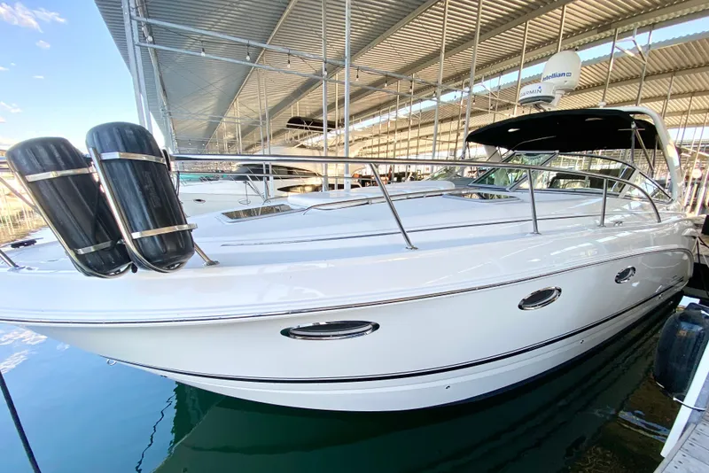 Slide: The Image of 2004 Chaparral Signature 330 boat docked under a covered marina. - 2