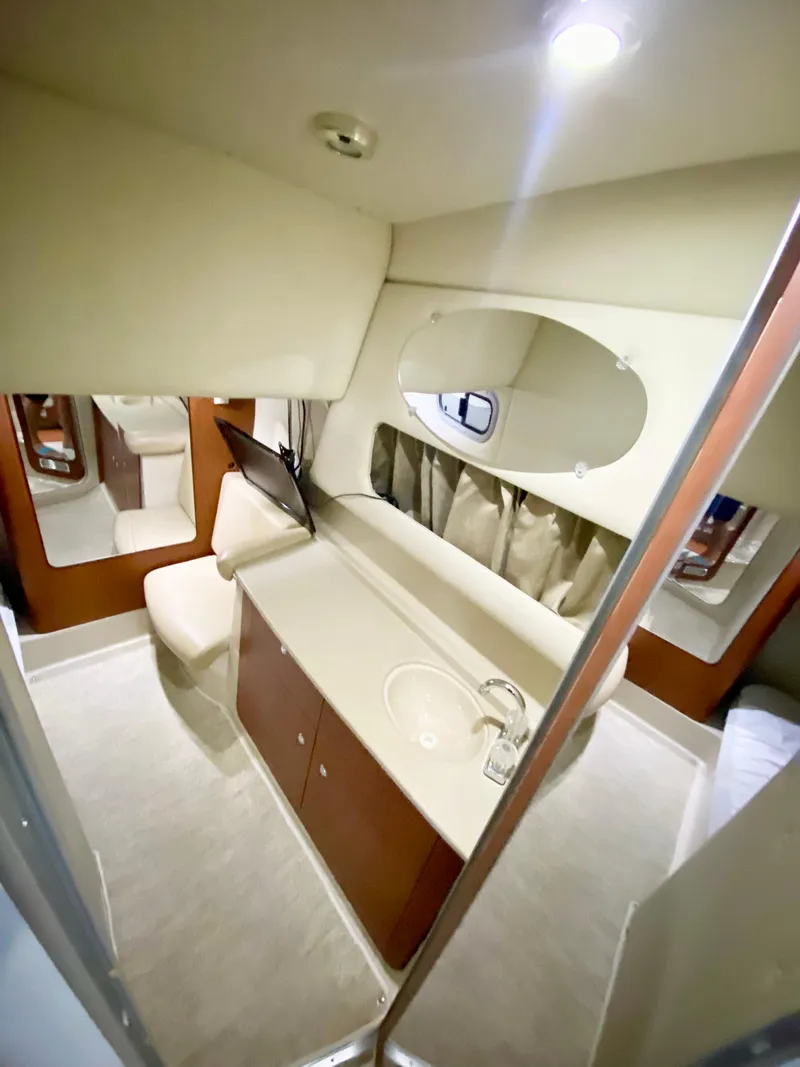 Slide: The Image of 2004 Chaparral Signature 330 cabin interior with modern amenities and sleek design. - 23