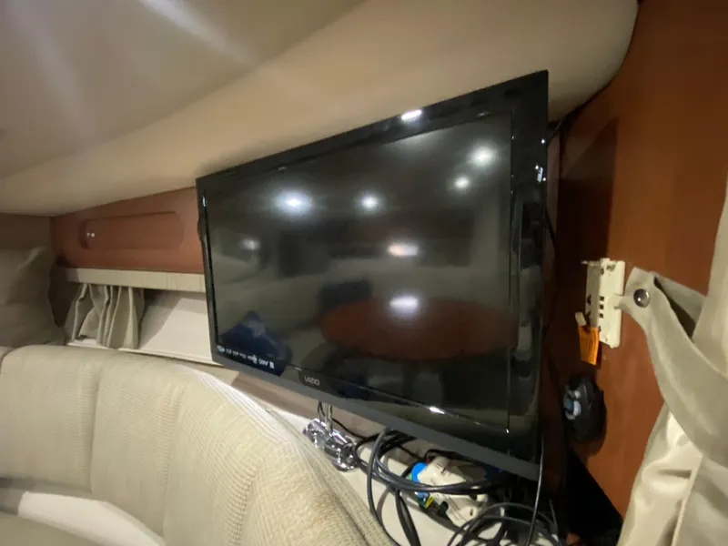 Slide: The Image of Interior of 2004 Chaparral Signature 330 with mounted TV and cozy seating area. - 28
