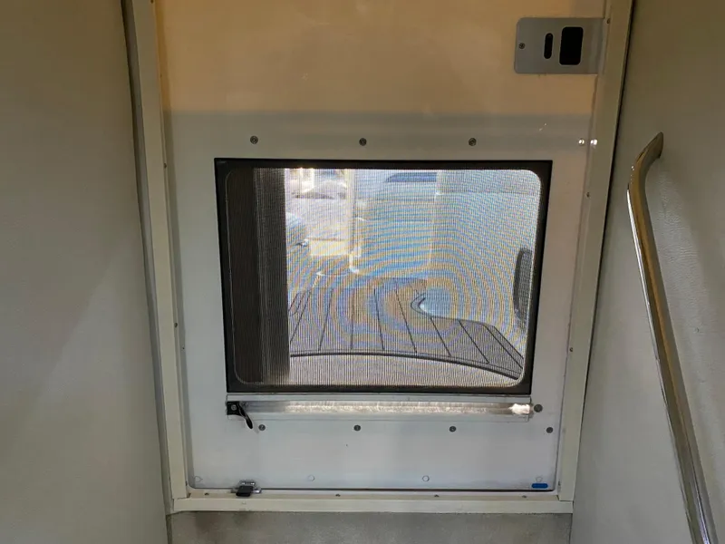 Slide: The Image of Interior view of a 2004 Chaparral Signature 330 boat door with mesh screen. - 32