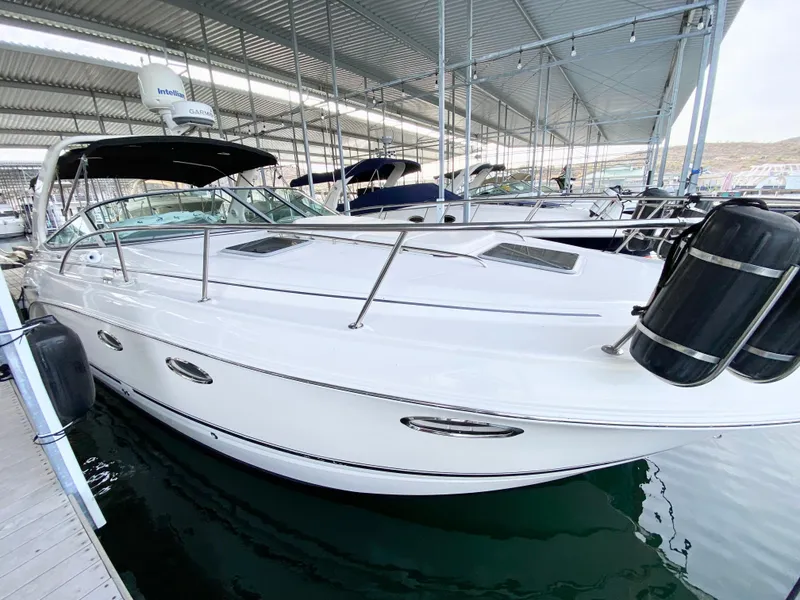 Slide: The Image of 2004 Chaparral Signature 330 boat docked in a marina under a covered shelter. - 36