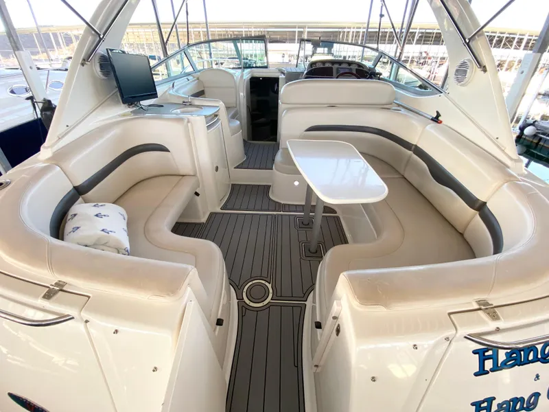 Slide: The Image of 2004 Chaparral Signature 330 yacht interior with seating, table, and TV. - 5