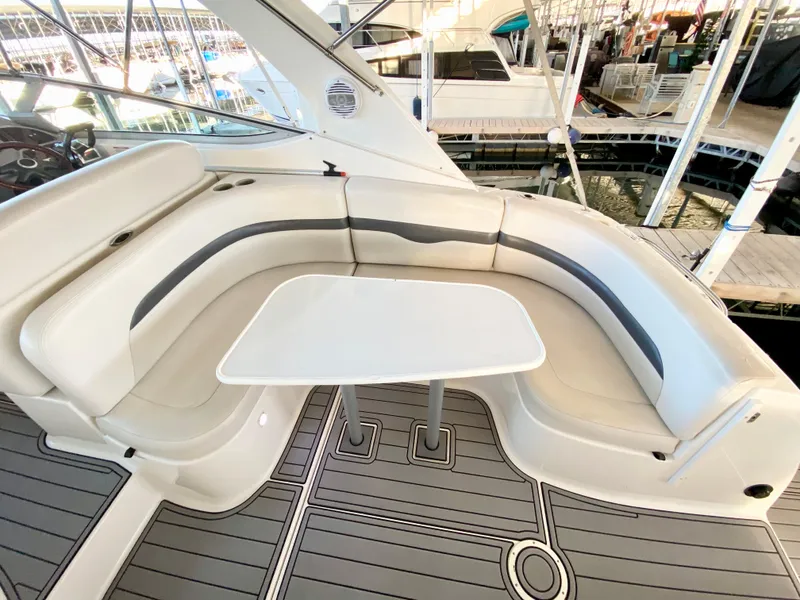 Slide: The Image of 2004 Chaparral Signature 330 boat interior with curved seating and table. - 6