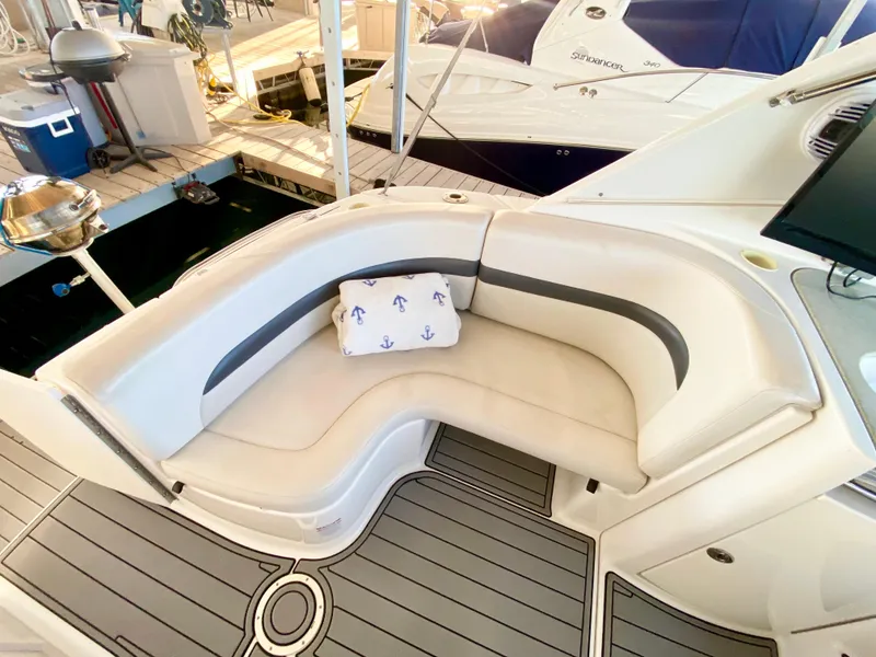 Slide: The Image of 2004 Chaparral Signature 330 boat with curved seating and anchor-themed pillow. - 7