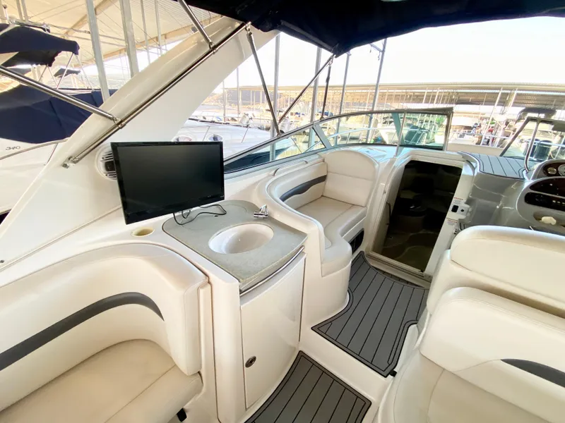 Slide: The Image of 2004 Chaparral Signature 330 yacht interior with seating, sink, and mounted TV. - 8