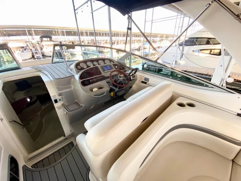 Slide: The Image of 2004 Chaparral Signature 330 boat interior with helm, steering wheel, and seating area. - 9