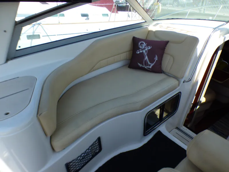 Slide: The Image of 2001 Monterey 302 Cruiser interior with beige seating and anchor-themed pillow. - 10