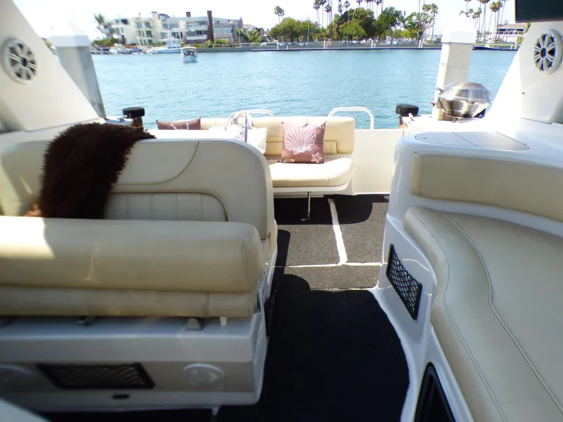 Slide: The Image of 2001 Monterey 302 Cruiser interior with beige seating, overlooking a scenic waterfront. - 16