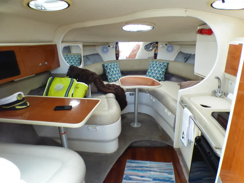 Slide: The Image of Interior of a 2001 Monterey 302 Cruiser with seating, table, and kitchenette. - 17