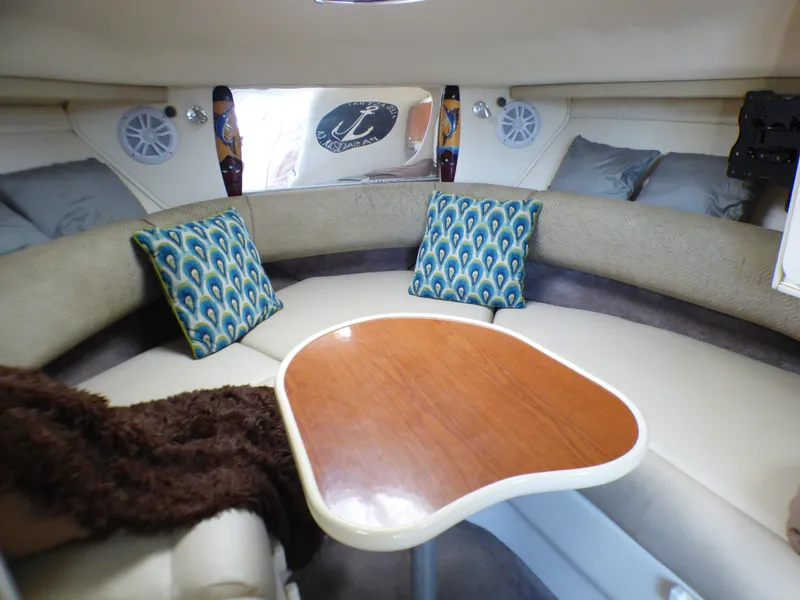 Slide: The Image of Interior of 2001 Monterey 302 Cruiser with cozy seating and decorative pillows. - 18