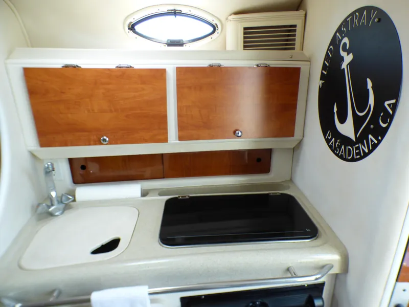 Slide: The Image of 2001 Monterey 302 Cruiser kitchen area with wooden cabinets and sink. - 20