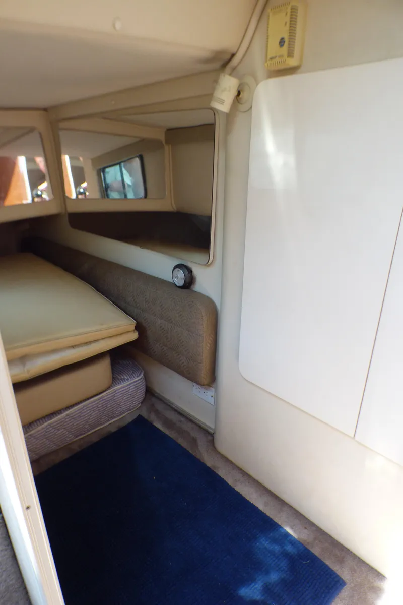 Slide: The Image of Interior cabin of 2001 Monterey 302 Cruiser with beige upholstery and blue carpet. - 23