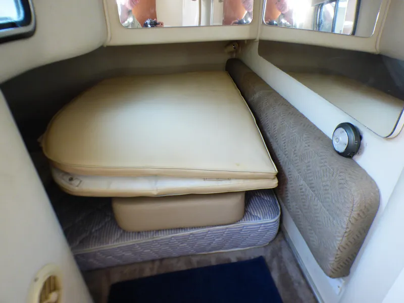 Slide: The Image of Interior cabin of 2001 Monterey 302 Cruiser with cushioned seating and bedding. - 25