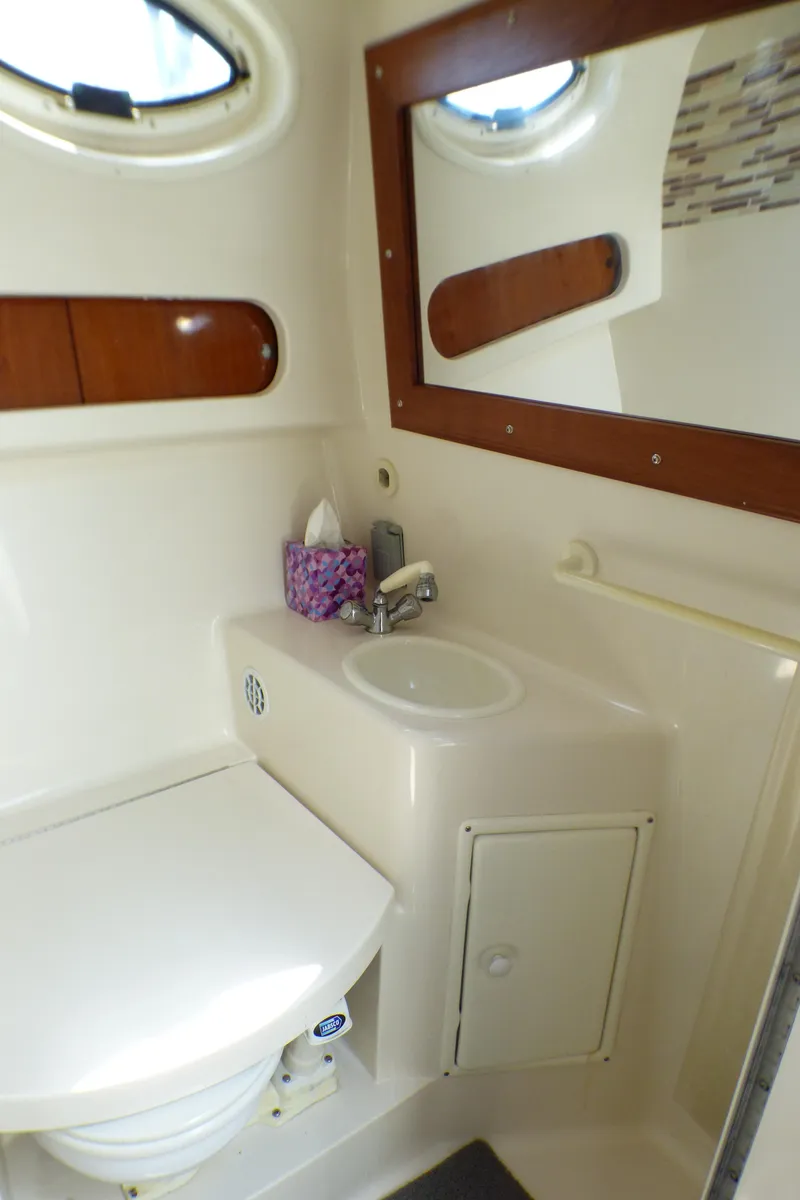 Slide: The Image of Bathroom interior of 2001 Monterey 302 Cruiser with sink, toilet, and mirror. - 26