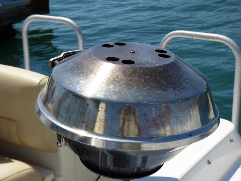 Slide: The Image of Stainless steel grill on a 2001 Monterey 302 Cruiser boat by the water. - 29