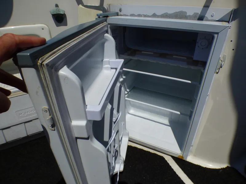 Slide: The Image of Open refrigerator on a 2001 Monterey 302 Cruiser boat, showing interior shelves. - 31