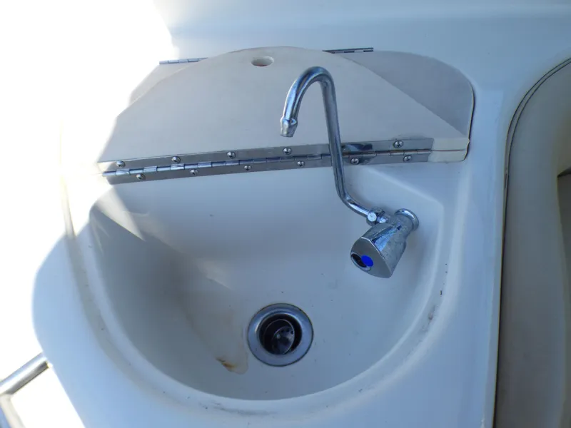 Slide: The Image of 2001 Monterey 302 Cruiser sink with chrome faucet in boat interior. - 32