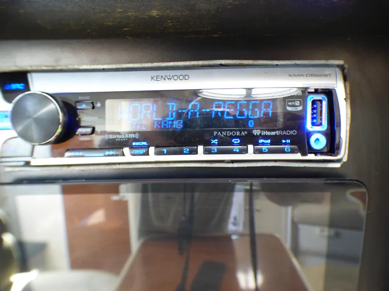 Slide: The Image of Kenwood stereo system in 2001 Monterey 302 Cruiser displaying "World-A-Regga". - 34