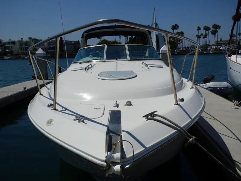 Slide: The Image of 2001 Monterey 302 Cruiser docked at marina, sunny day, calm water, palm trees in background. - 4
