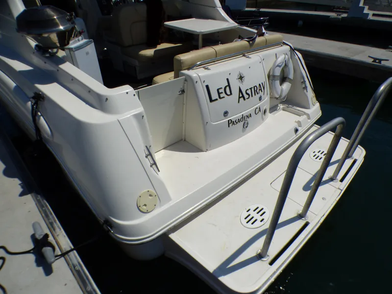 Slide: The Image of 2001 Monterey 302 Cruiser boat docked, featuring rear deck and seating area. - 6