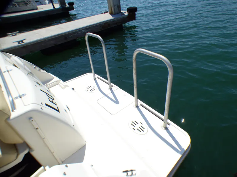 Slide: The Image of 2001 Monterey 302 Cruiser swim platform with ladder, docked on calm water. - 7